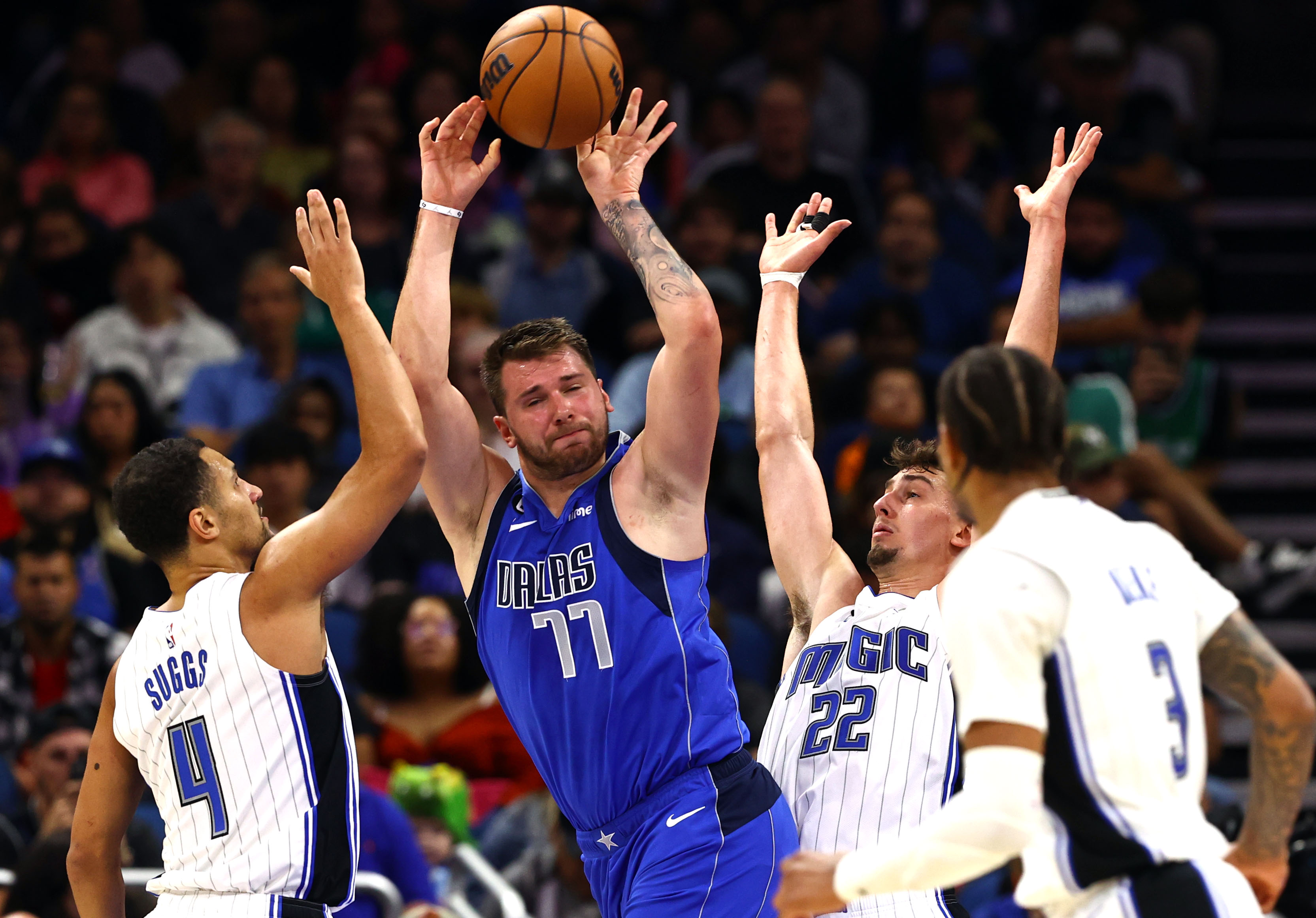 Dallas Mavericks guard Luka Doncic (77) drives to the basket as Orlando Magic guard Jalen Suggs (4) and forward Franz Wagner (22) defend during the second half at Amway Center.